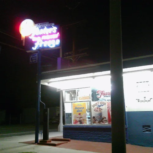 a neon sign and building for a Foster's 
			Freeze ice cream and hamburger stand at night.